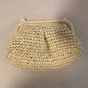 Raffia effect clutch with attachable metallic strap